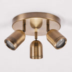 Lucca antique brass triple spotlight ceiling plate, angled view on white
