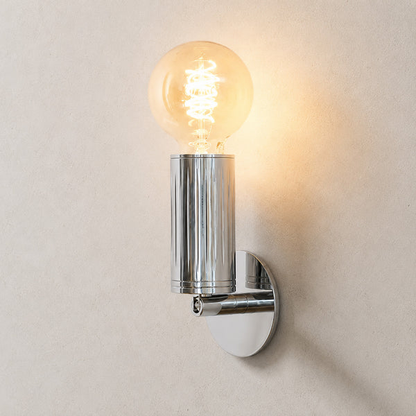 Luminar polished steel wall lamp with exposed globe filament bulb, lit
