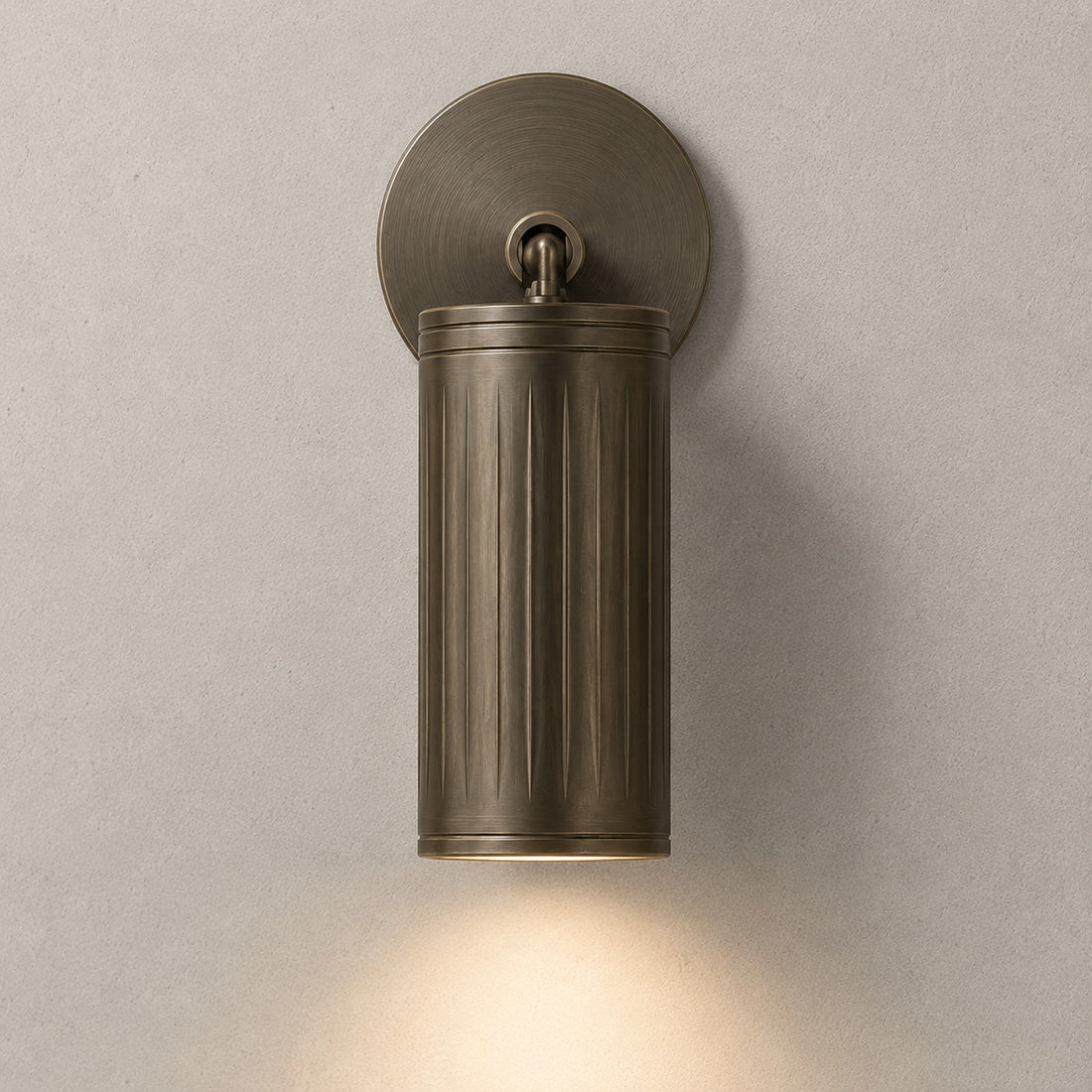 Luminar browned brass ribbed spotlight casting a downward beam
