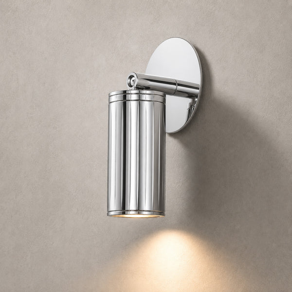 Luminar polished steel adjustable wall spotlight angled down, lit