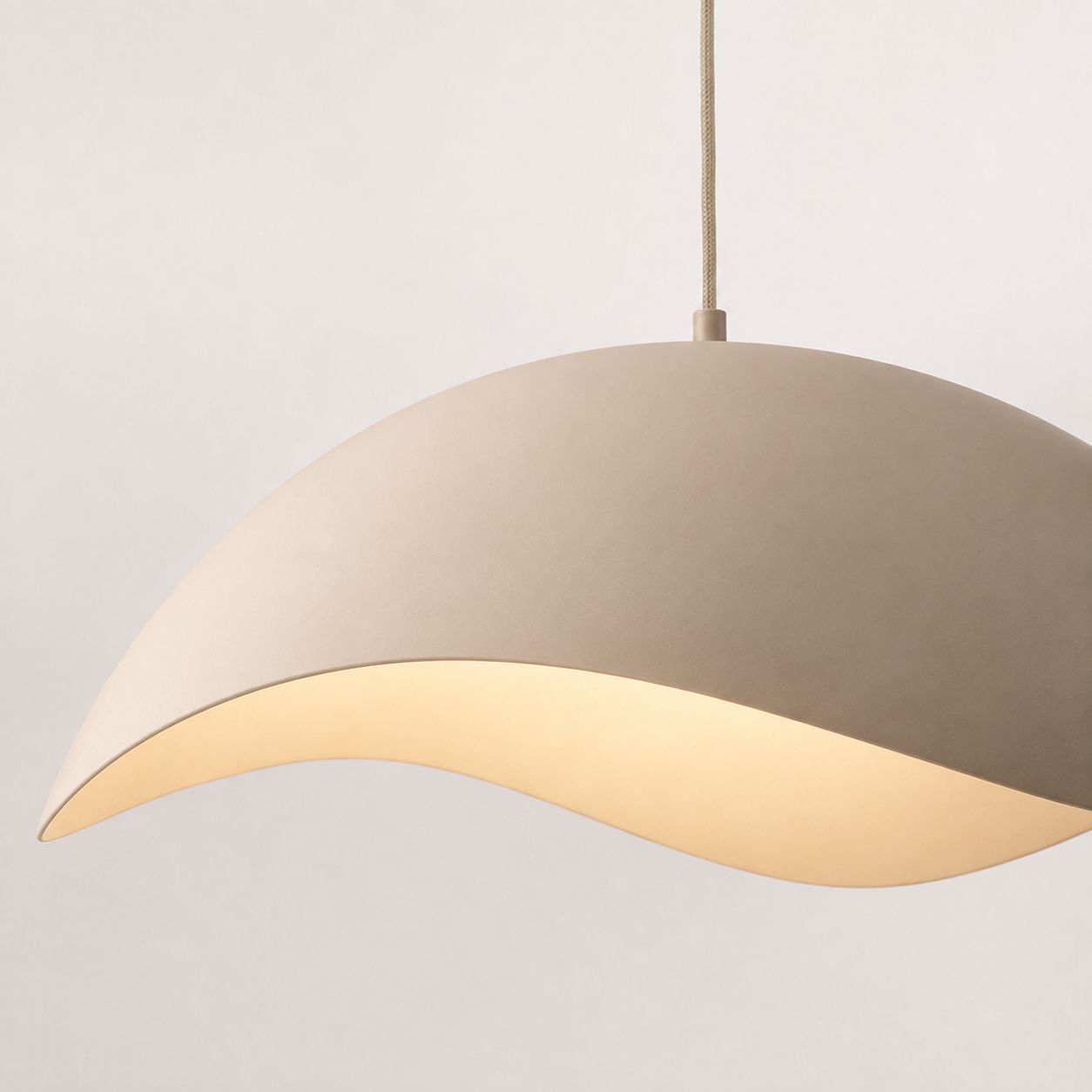 Nami sand taupe wave-shaped metal pendant light, side view on white