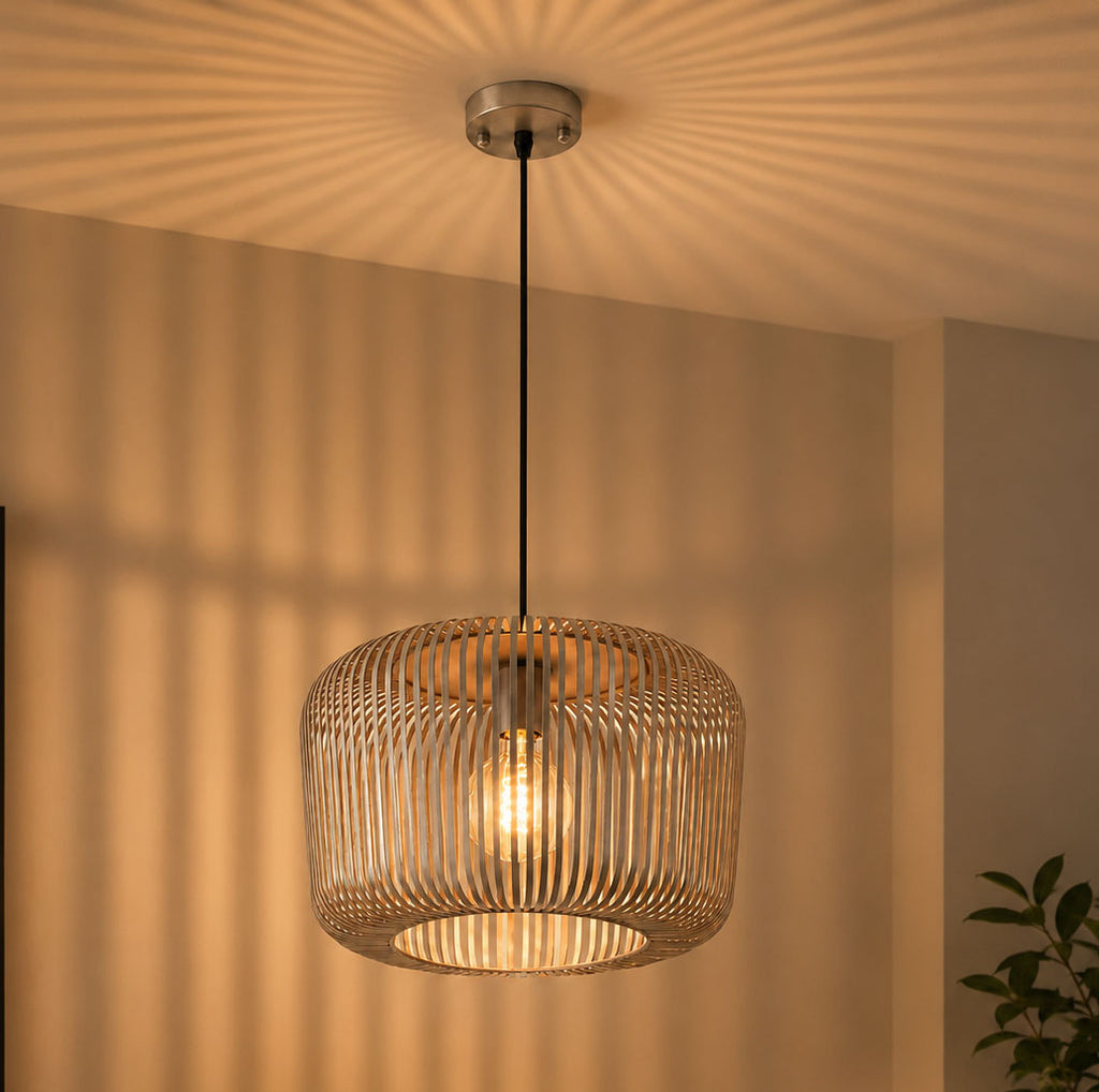 Woven pendant light hanging in a room with a couch and plant