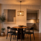 Raina grey wire pendant lit above a round dining table in a kitchen