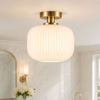 Rivoli white ribbed glass and antique brass ceiling light in a bathroom setting