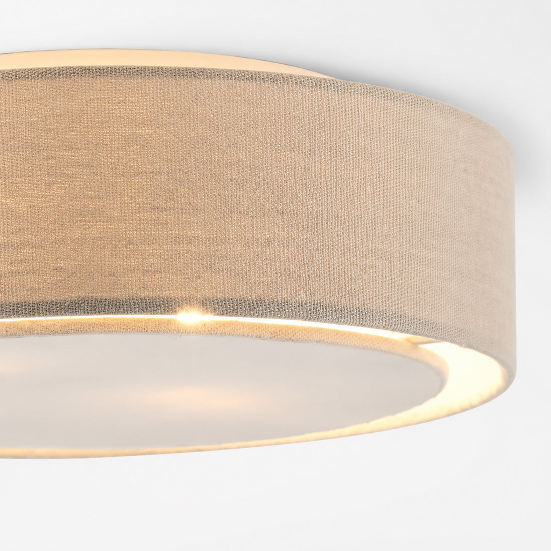 Warm glow through the natural linen drum and diffuser plate