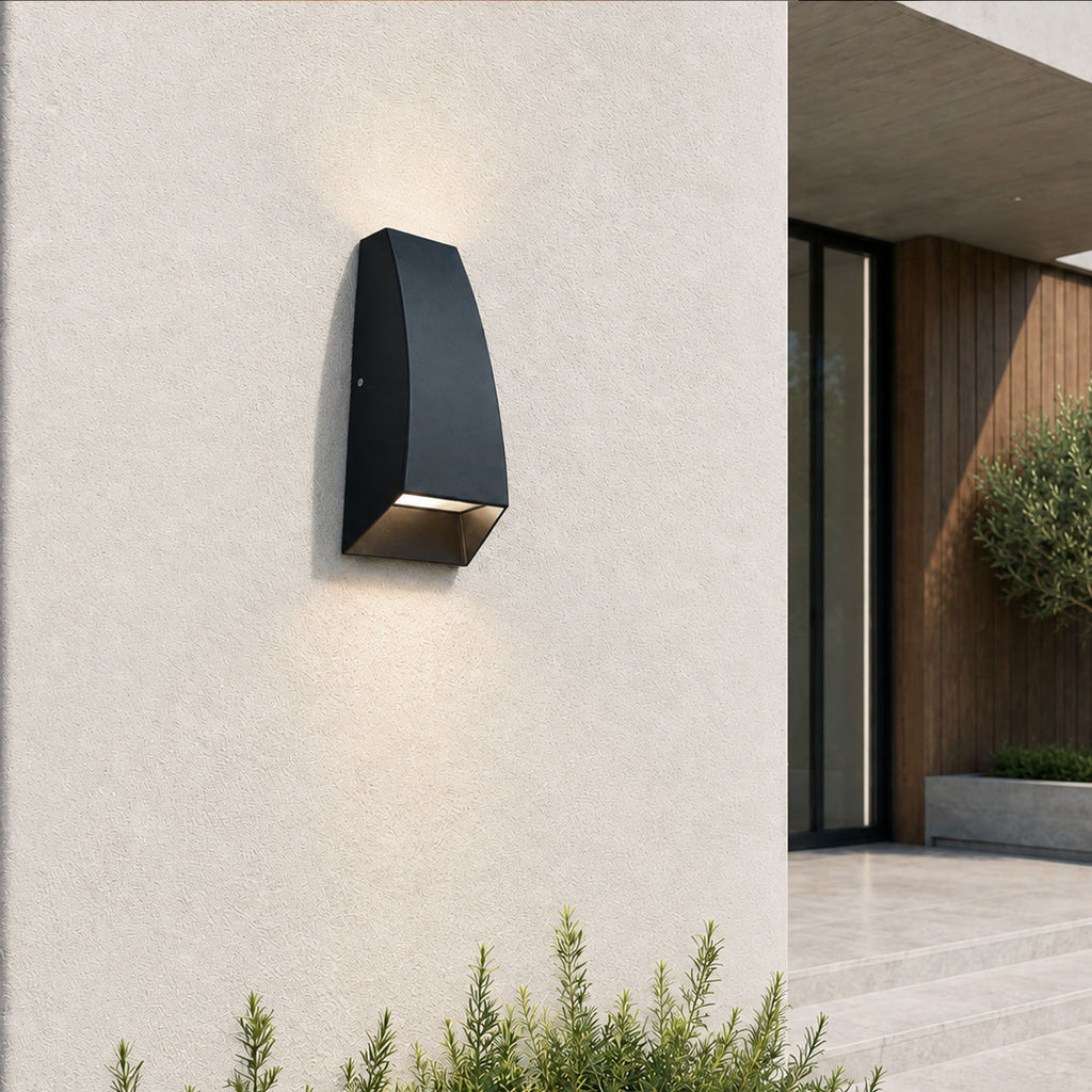 Silas black aluminium outdoor wall light on a white wall beside a modern house entrance