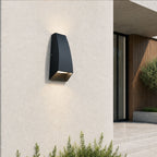 Silas black aluminium outdoor wall light on a white wall beside a modern house entrance