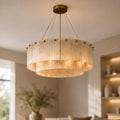 Two-tier alabaster ring chandelier with brass studs over a neutral lounge