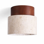 Tavira natural travertine flush ceiling light with dark wood cap, angled view on white