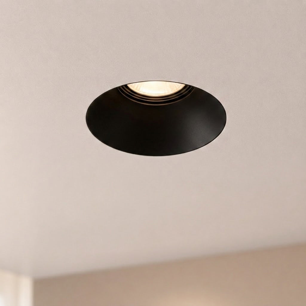 Matt black Kanto Mini recessed downlight in a smooth plastered ceiling