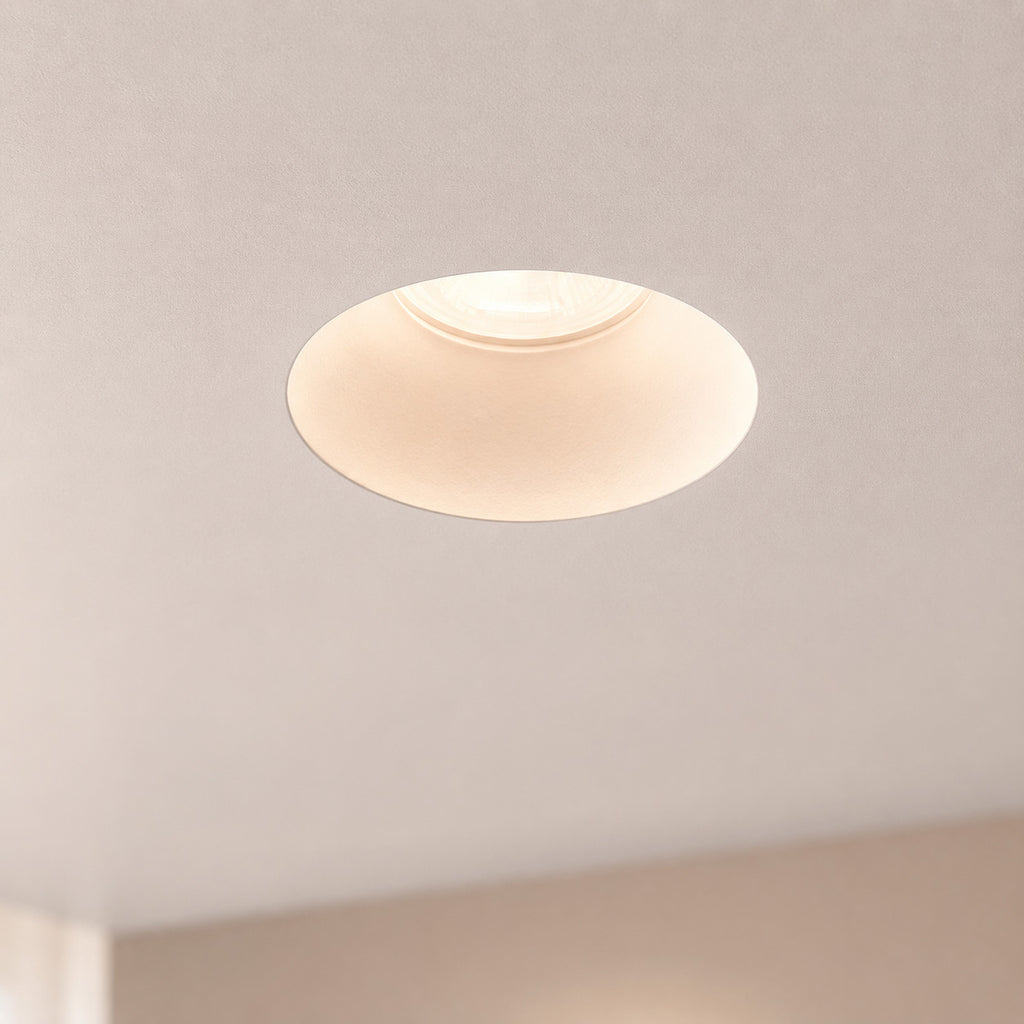 Matt white Kanto fixed trimless downlight nearly invisible in a plastered ceiling