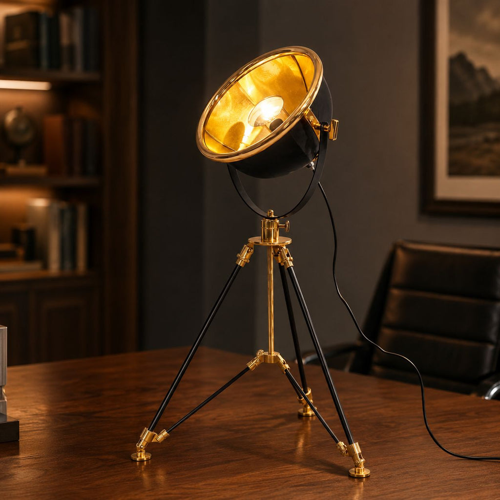 Valen tripod table lamp with black dish shade and brass legs on a desk