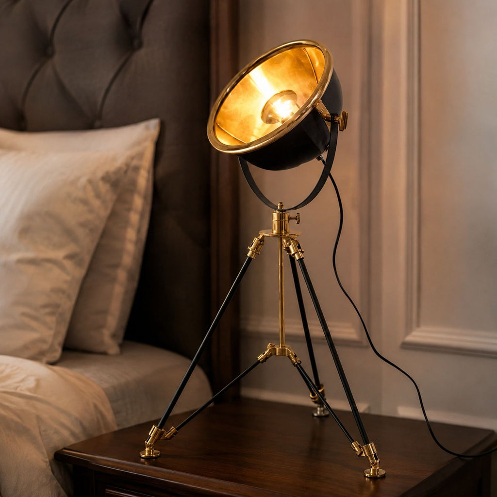 Valen tripod lamp with gold-lined dish on a bedside table beside a headboard