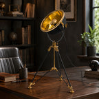 Valen black and brass tripod lamp on a study desk with leather chair