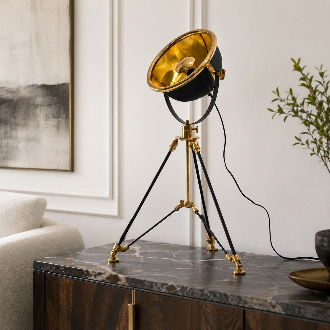 Valen tripod table lamp with gold reflector on a marble console table