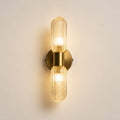 Verona double capsule sconce lit straight-on showing brass backplate