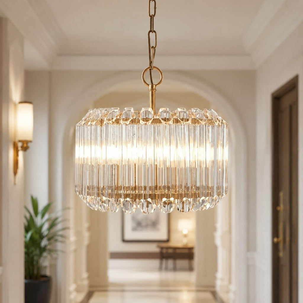 Veyra gold crystal glass drum pendant on a chain, lit in a hallway