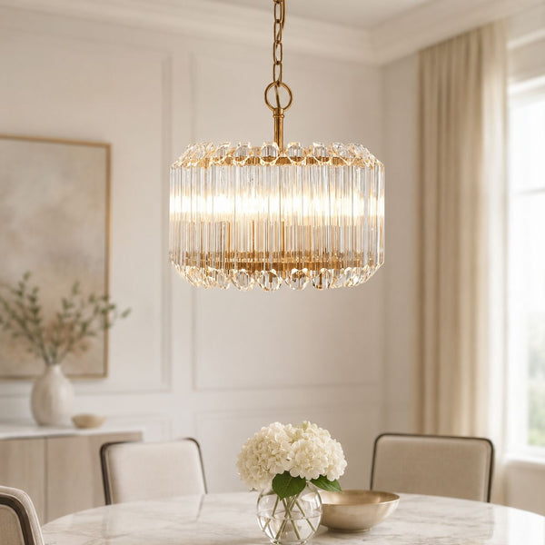 Veyra 3-light gold drum pendant with crystal glass rods hung above a dining table
