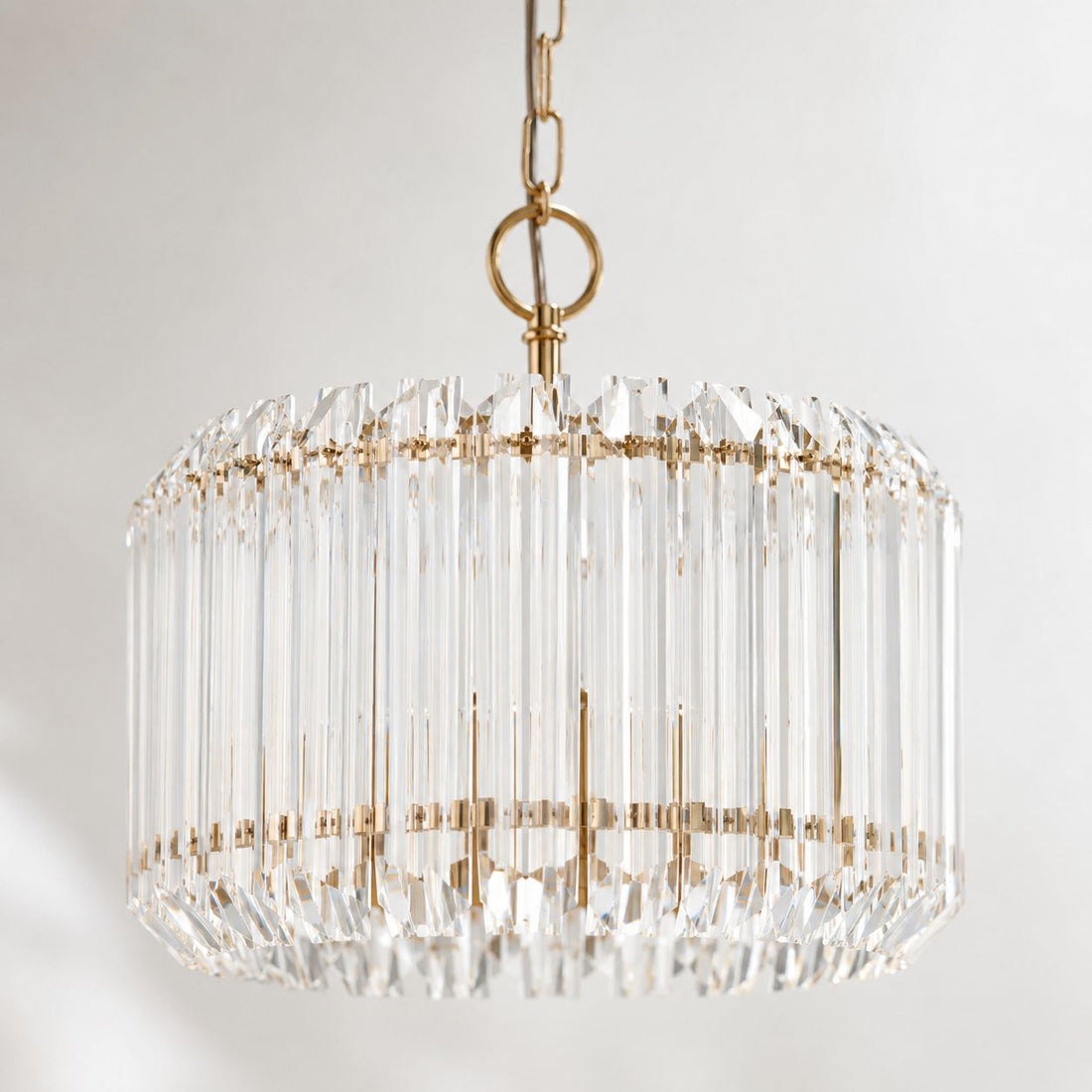 Veyra 3-light gold drum pendant with faceted glass rods, close-up on white