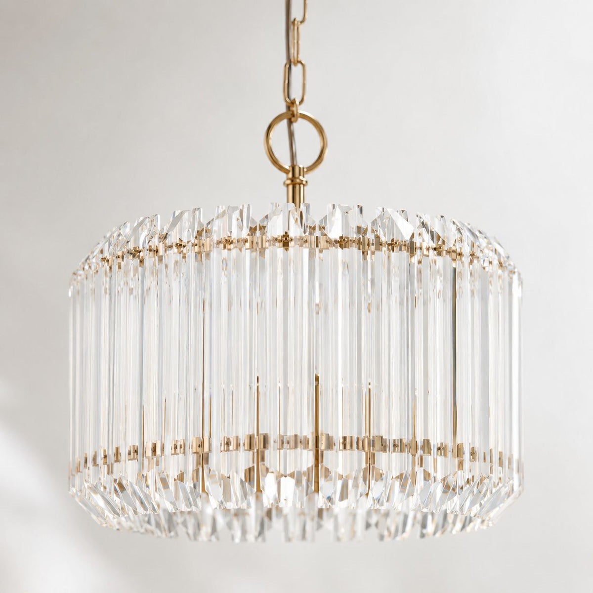Veyra 3-light gold drum pendant with faceted glass rods, close-up on white