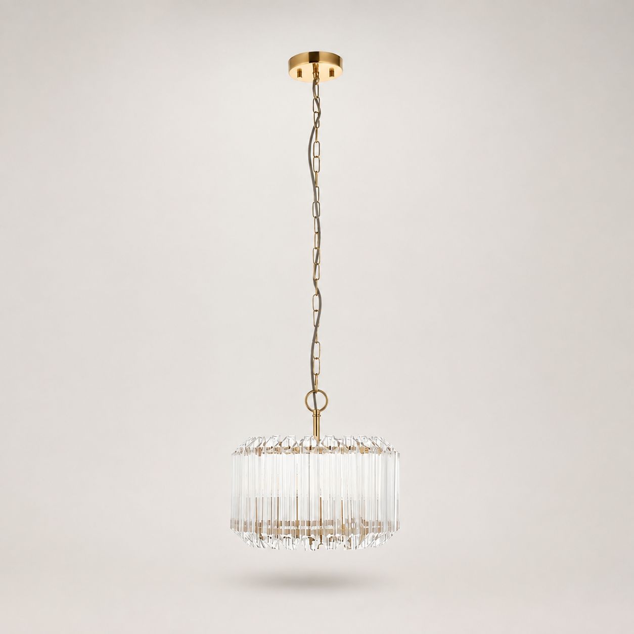 Veyra gold and glass drum pendant on a long chain, full view on white