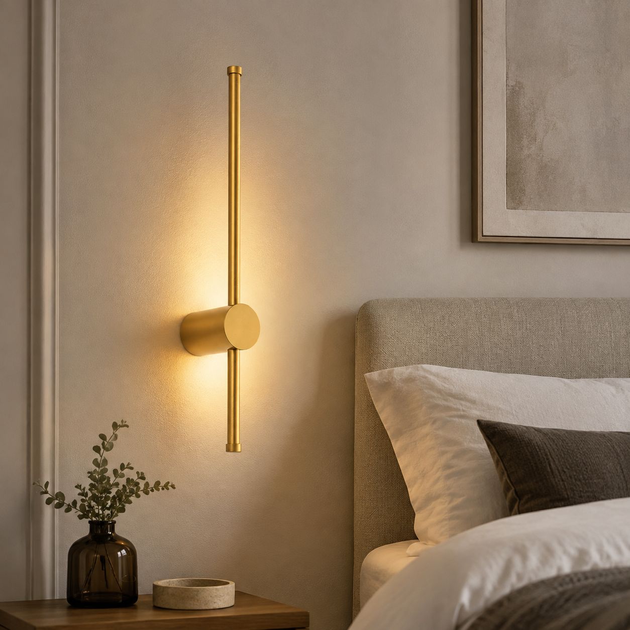 Vireo brushed gold LED stick wall light above a bedside table
