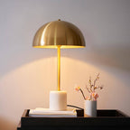 Camilla gold and marble table lamp with fabric shade on bedside table