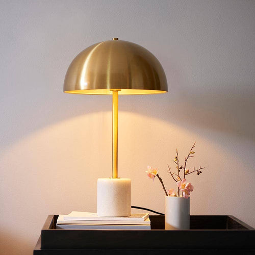 Camilla gold and marble table lamp with fabric shade on bedside table