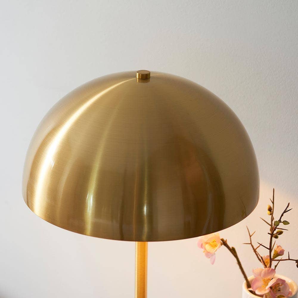 Camilla table lamp illuminated in modern living room setting