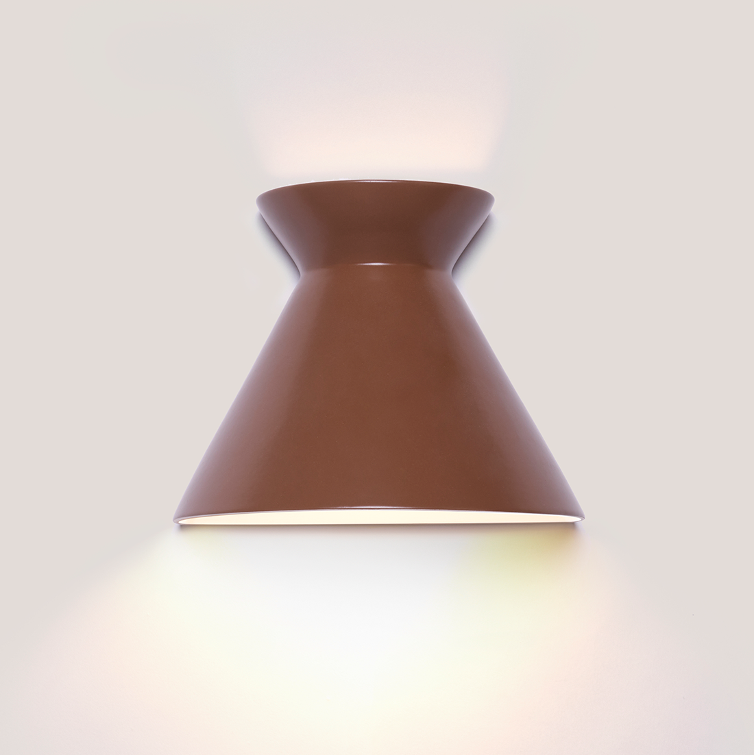 Kiro large russet brown ceramic wall light casting light up and down
