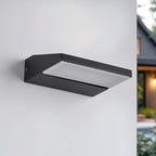 Renzo outdoor wall light in black finish illuminated at night