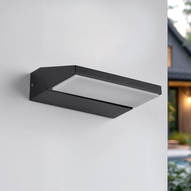 Renzo outdoor wall light in black finish illuminated at night