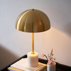 Close up of Camilla lamp showing gold metal stem and white marble base