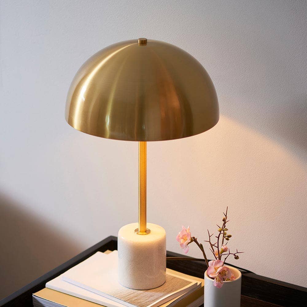 Close up of Camilla lamp showing gold metal stem and white marble base