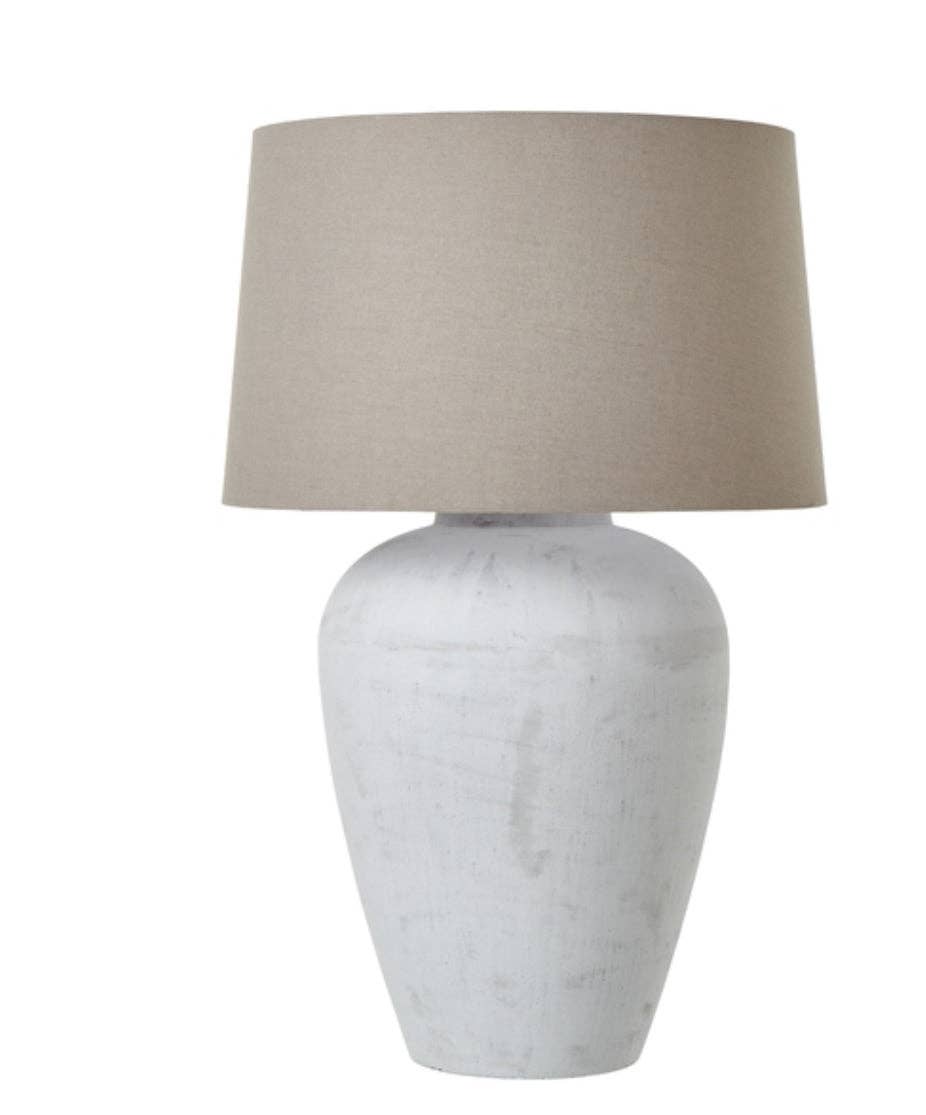 Athena tall aged stone table lamp with natural linen shade on sideboard