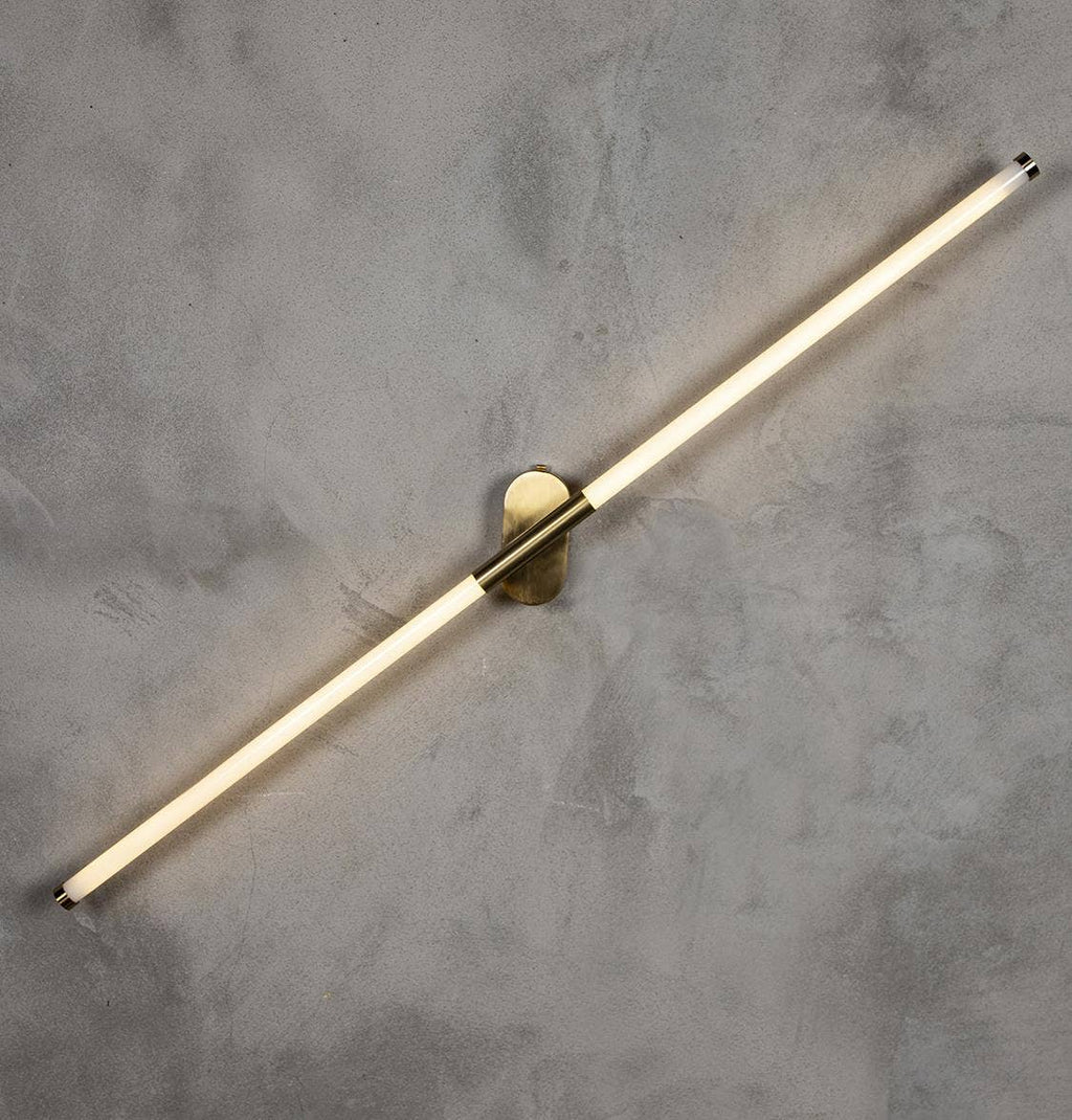 Akra wall light installed showing warm LED glow in modern interior