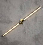 Akra antiqued metal LED wall light 80cm mounted on white wall showing warm diffused glow
