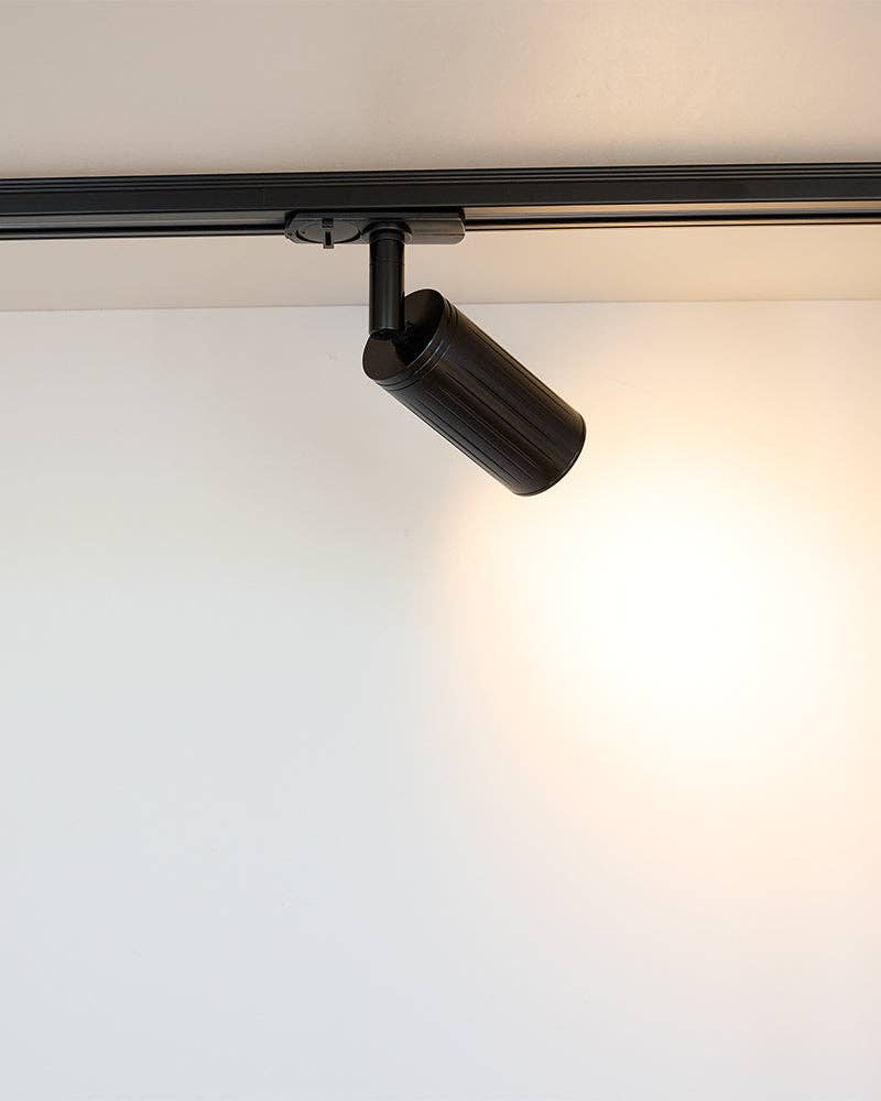 Luminar Track Mount Spotlight — Black in a room