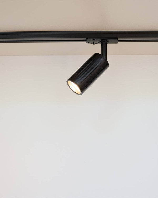 Luminar black track mounted spotlight on white ceiling