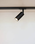 Luminar black track mounted spotlight on white ceiling