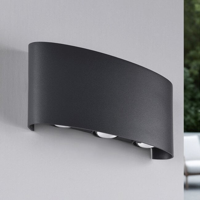 Kyra outdoor wall light illuminated at night showing upward and downward light effect