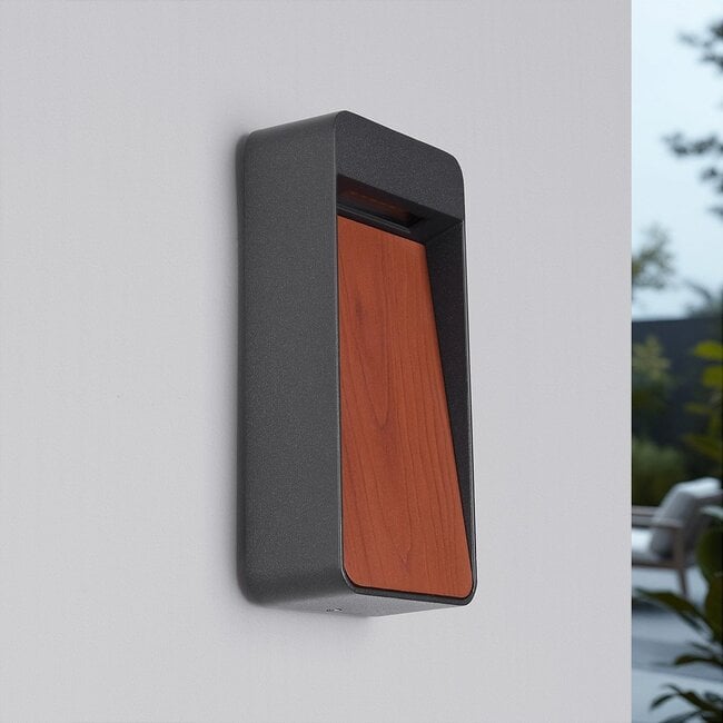 Laska outdoor wall light illuminated at night displaying warm white LED glow on home exterior