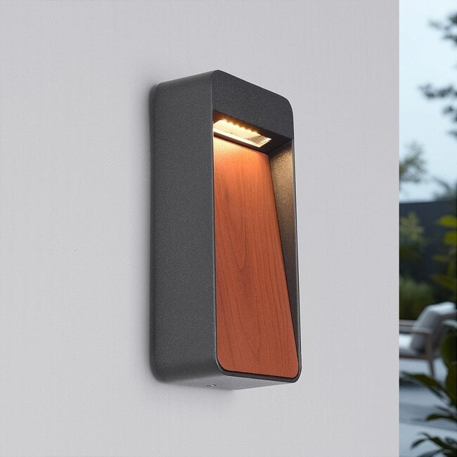 Close-up of Laska warm white LED wall light showing wood grain and anthracite metal detail