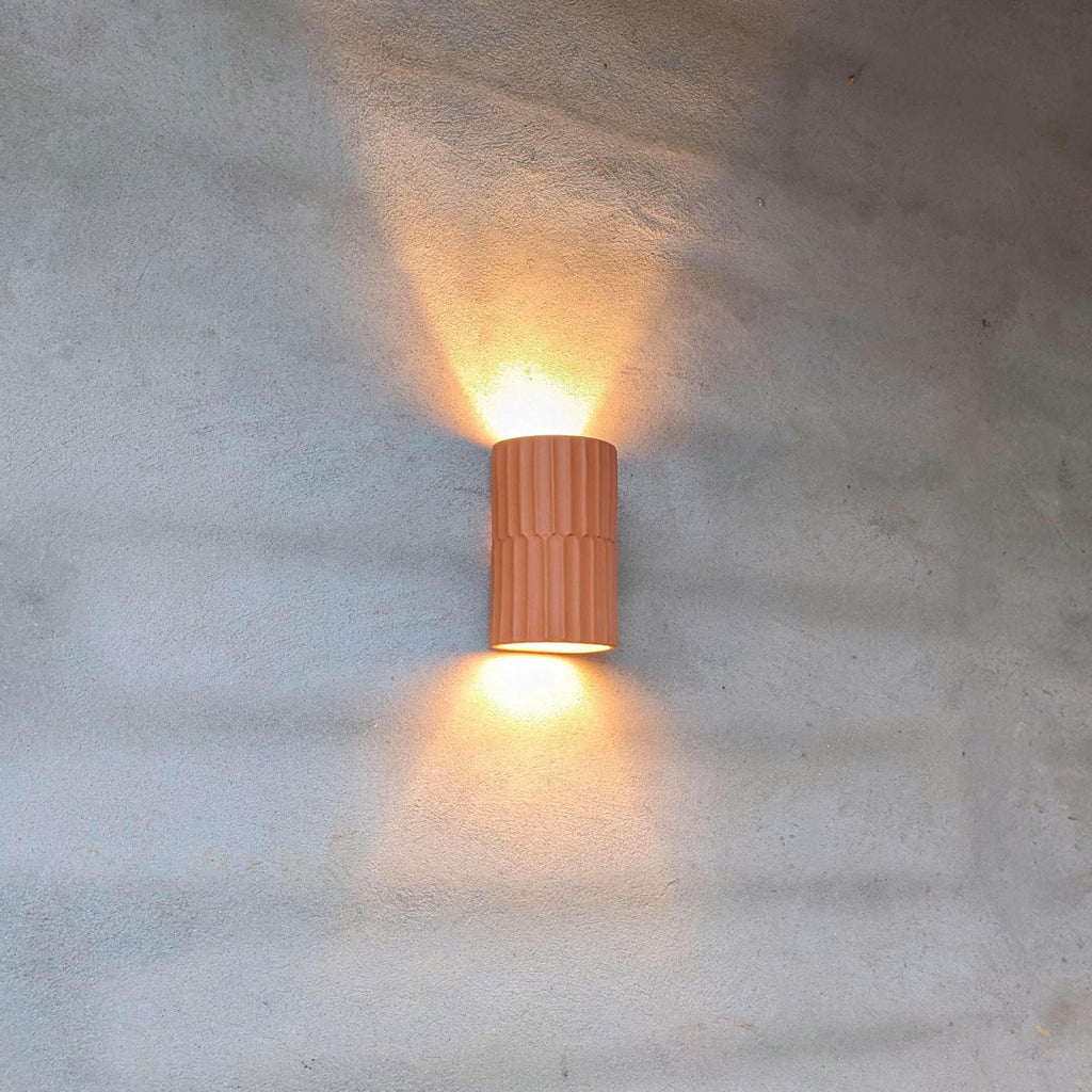 Close-up of artisan fluted ceramic detailing on Terra wall sconce