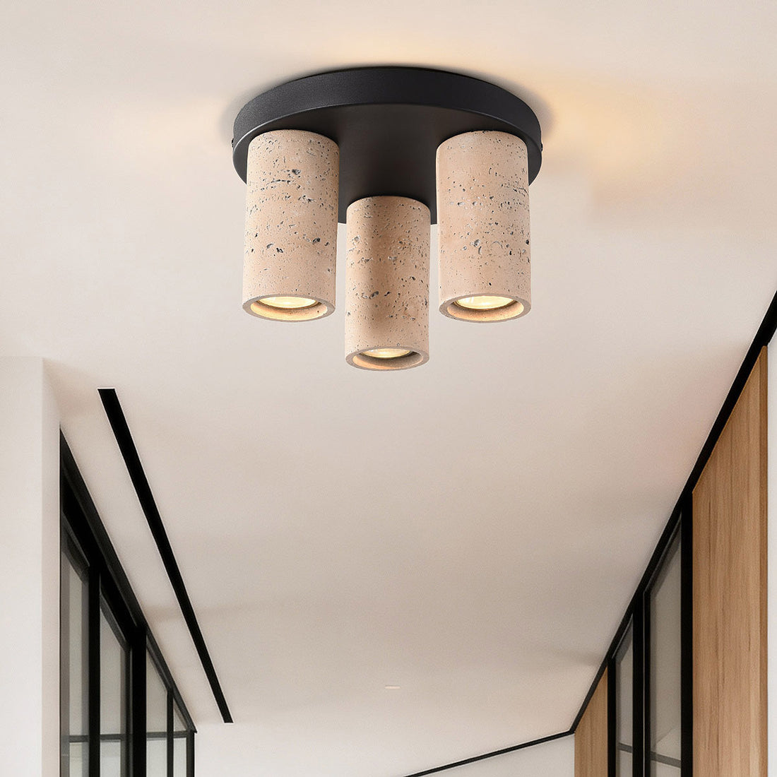 Three adjustable spotlight heads with textured travertine effect concrete detail