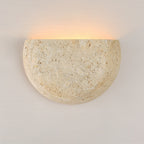 Wara travertine wall light installed in hallway creating ambient wall washing effect