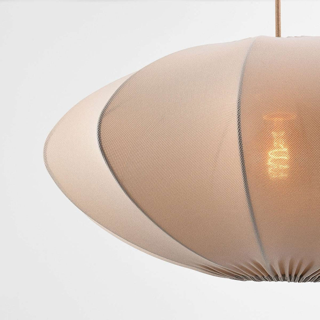 Elva pendant light illuminated showing warm ambient lighting effect