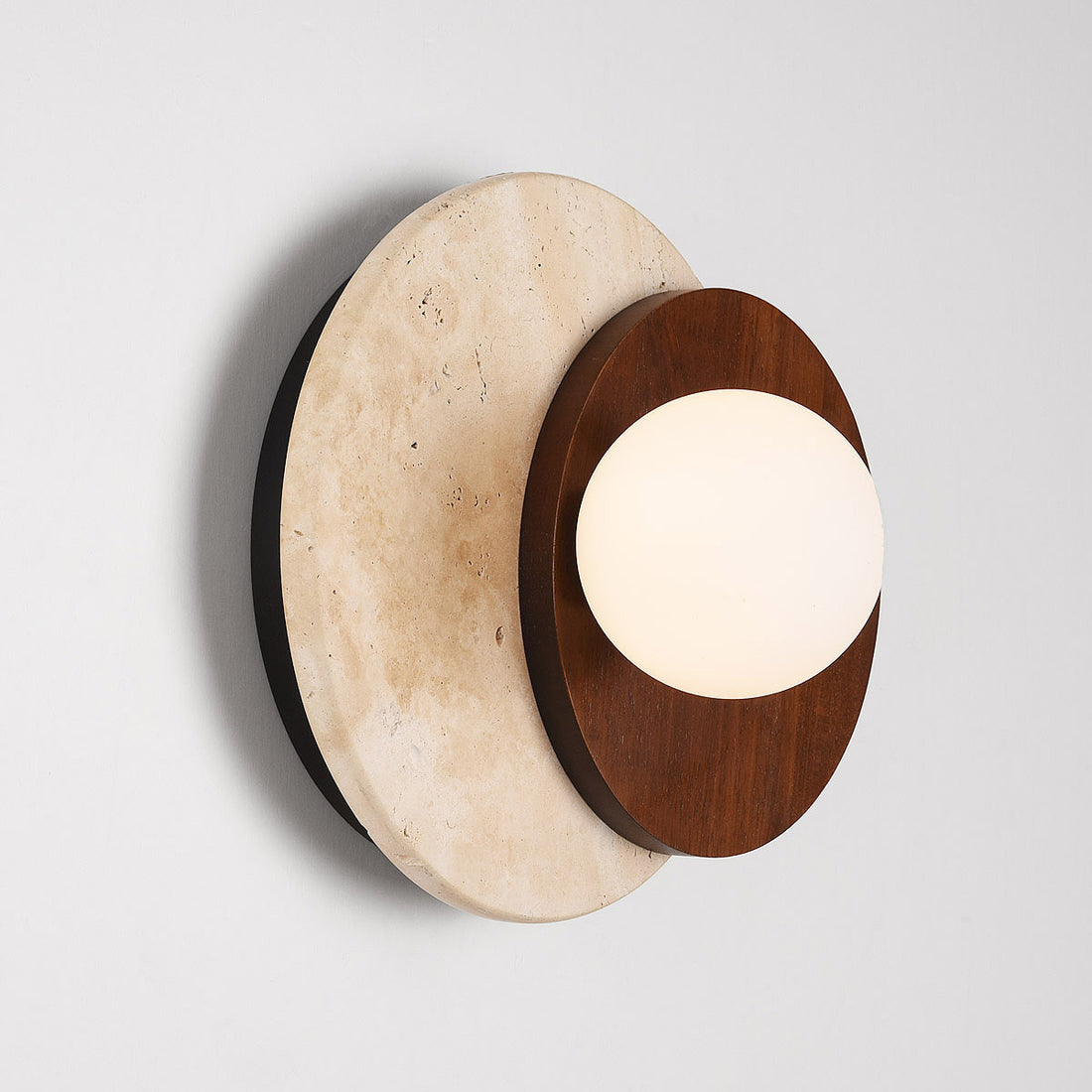 Yori travertine wall light showing sculptural profile and materials texture
