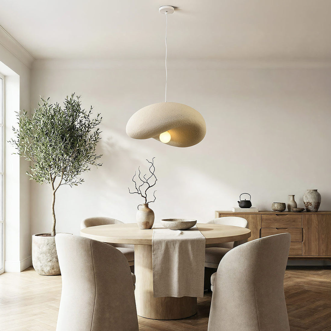 Close-up of Kaia pendant light showing textured speckled sand surface and asymmetrical curved shape