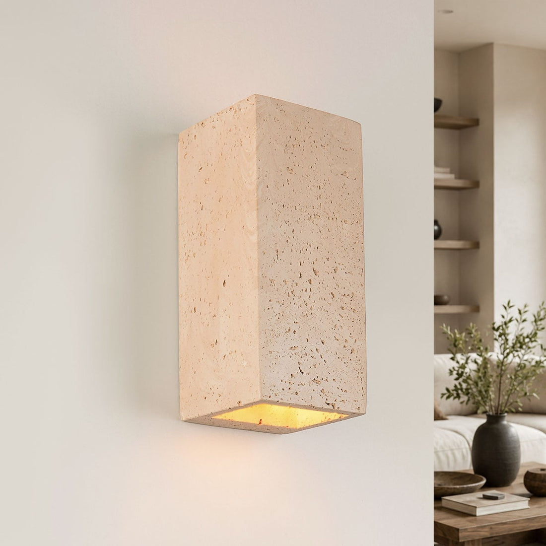 Cubo cement wall light with travertine finish showing up and down light beams on white wall
